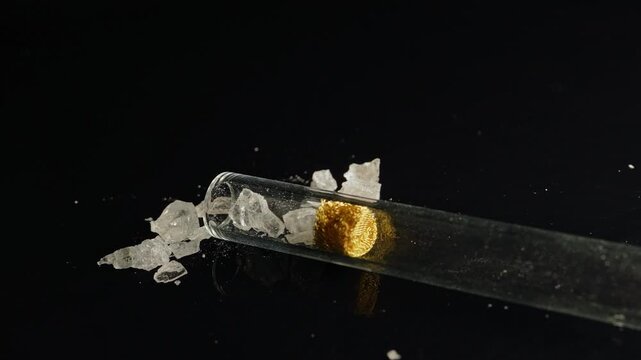 Crystal meth drug in rocks with smoking crack pipe on the table of addict. Addiction and drugs trafficking. Illicit drugs very potent and addictive, substances altered for street sale by drug dealer.