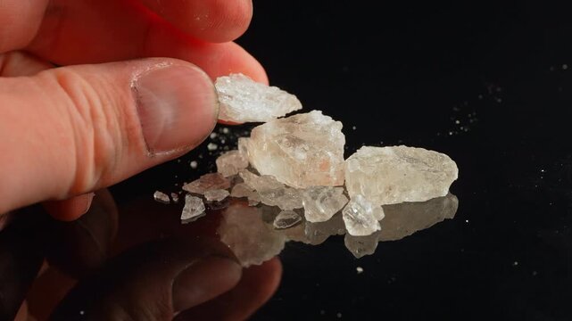 Methamphetamine drug in rocks. Crystal meth or methamphetamine a recreational and highly potent and addictive drug. Crack cocaine in hard form of crystals. Addiction and drug trafficking.