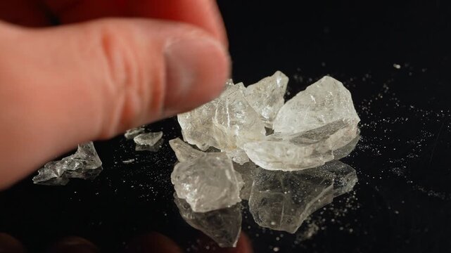 Methamphetamine drug in rocks. Crystal meth or methamphetamine a recreational and highly potent and addictive drug. Crack cocaine in hard form of crystals. Addiction and drug trafficking.