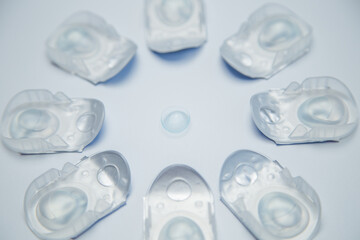 Creative flower layout of one-day contact lenses in disposable protective packaging, in the center...