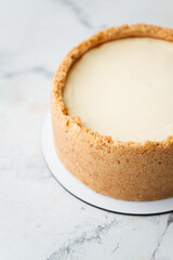  Close up view of classical traditional New York Cheesecake on the white marble background