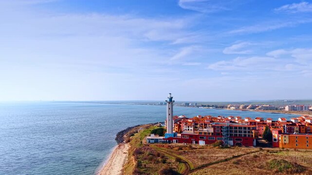Going up over the Aheloy Lighthouse and Marina Cape complex in Aheloy, Bulgaria. Revealing view on the vast waterscape of the Black Sea.
