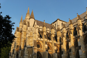 Stunning architecture of London's Westminster Abbey under a clear blue sky during late afternoon