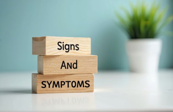 Wooden cubes with text. Words sign and symptoms on blocks. Medical concept for health problems awareness. Health care information. Healthcare and medicine concept related to illness.