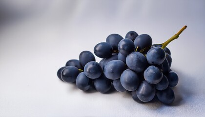 Fototapeta premium Creamy White Texture With Dark Grapes In A Close Up View On A Light Background