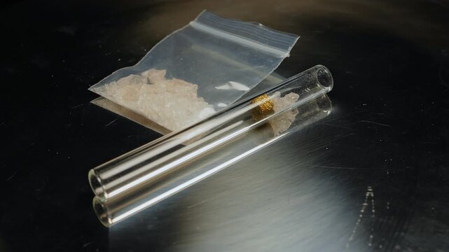 Methamphetamine drug in a plastic bag. Crystal meth or methamphetamine a recreational and highly potent and addictive drug. Crack cocaine in hard form of crystals. Addiction and drug trafficking.