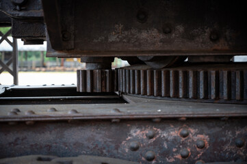 Detail of the massive, rusted gear mechanism for the slewing/swing function of the historic steam shovel, a colossal 1922 mining machine.