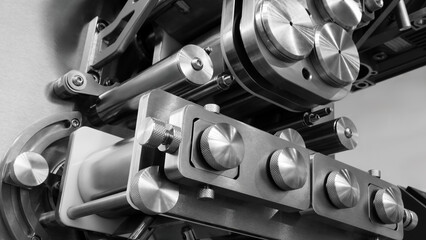 Candy and cake making machine with silver surface and bright light on it. The machine is used for...