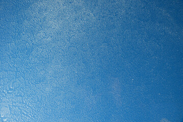 frosted glass of roof window with blue sky behind