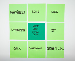 Inspirational sticky notes arranged in a grid with positive words. Concept of mindset, positivity, motivation and emotional wellbeing.