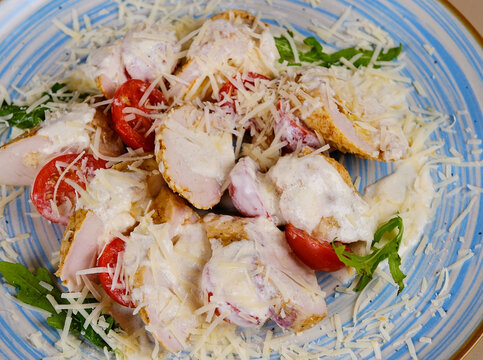 Classic caesar salad with grilled chicken fillet and parmesan cheese. top view. High quality photo