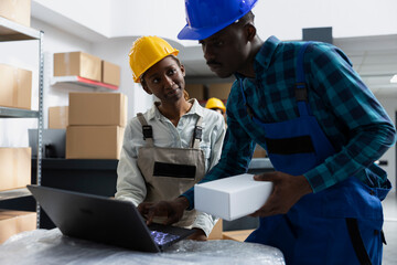 African american workers team prepare packages for a new shipment at the storehouse, working on products delivery. Logistics center systems with cargo on shelving units, manual work.