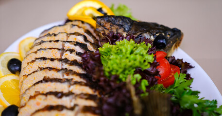 stuffed fish Delicious stuffed carp with lemon and lettuce leaves. High quality photo