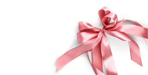 Pink satin gift bow isolated on white background. Holiday decoration silk ribbon, top view, border...