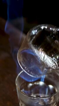 Bartender sets fire to cocktail, burning cinnamon in alcohol drink, per second, barman makes drink. High quality 4k footage