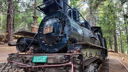 Naklejka premium Sierra Nevada Logging Museum looking a a vintage steam locomotive used to move timber from the mountains tho the sawmills near the town of Arnold, California, to show Timber Tech