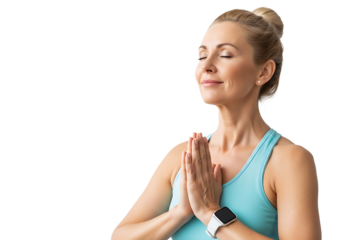 A serene, middle-aged woman with blonde hair in a bun meditates peacefully, eyes closed, hands in prayer pose at her heart. She wears a light blue tank top and a modern smartwatch, embodying calm mind