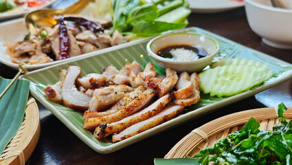 Grilled pork neck on a plate in an Isaan restaurant