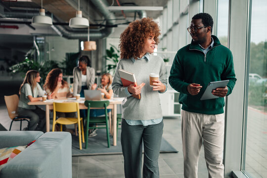Diverse business colleagues discussing ideas in modern office
