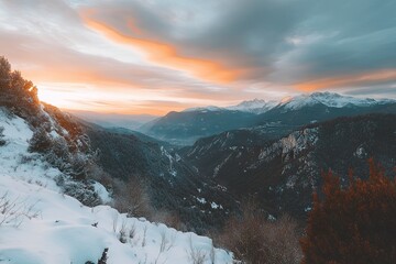A panoramic view of the snowy Alps with mountains in the background, snow-covered trees on hillsides