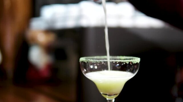 Hand serving margarita cocktail at Phuket beach bar setting. High quality 4k footage