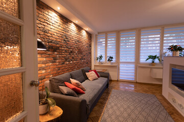 A Cozy and Modern Living Room Featuring a Stunning Brick Accent Wall that Enhances Its Charm