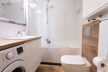 A Modern Bathroom featuring a Bathtub and Washer designed with a Clean and Stylish Aesthetic