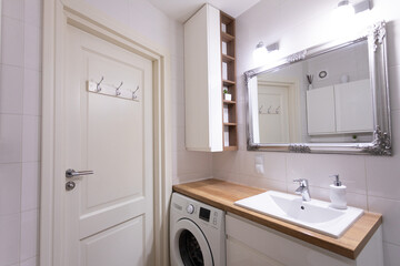 A modern laundry room designed with stylish fixtures and an appealing interior design aesthetic