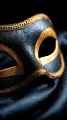 Elegant Black and Gold Decorative Mask on Dark Fabric