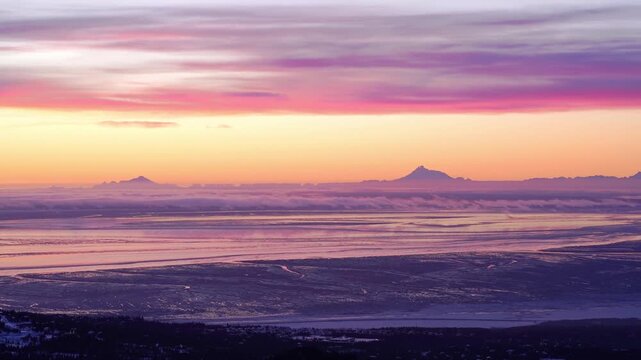 Timelapse of pink clouds with two volcanoes in Alaska. 12 seconds
