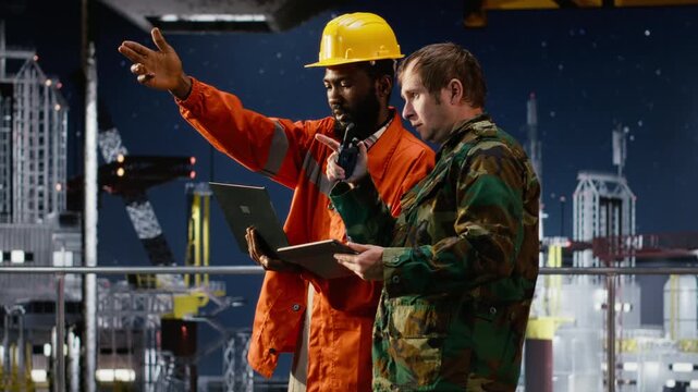 Naval officer and engineer using walkie talkie on oil rig vessel to manage threat response and border security operations, ensuring safe offshore drilling and protection of assets. Camera B.