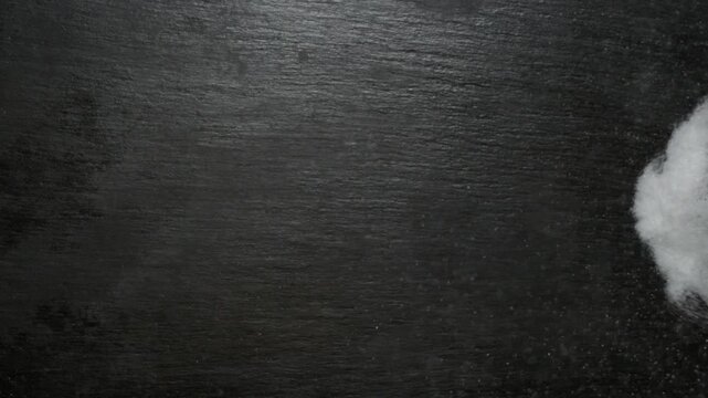 Sugar forming the word sugar on a dark surface