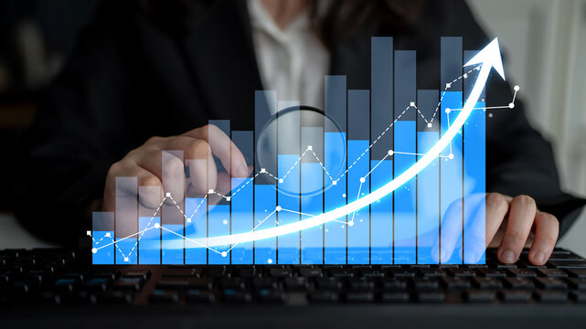 A business professional analyzes a growth chart on a computer keyboard, showcasing data visualization and graphing techniques for effective decision-making. Scalp - Powered by Adobe