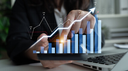 A professional individual examines growth trends using a smartphone and laptop while visualizing data through graphs, charts, and financial metrics in a modern workspace. Scalp