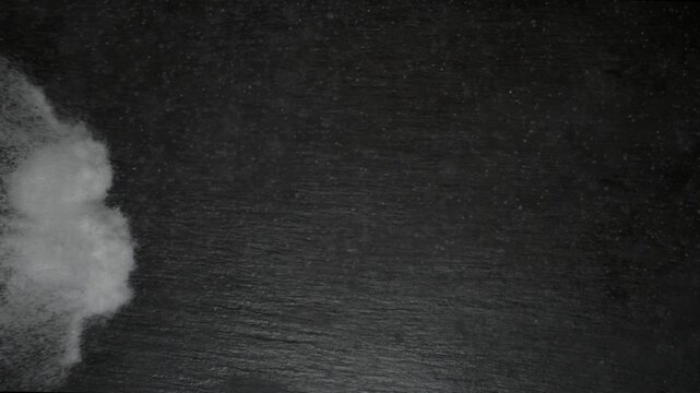 Sugar forming the word sugar on a dark surface