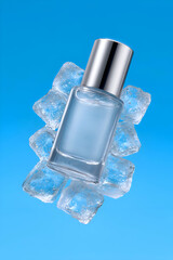 Glass perfume bottle with silver cap resting on clear ice cubes, floating against a vibrant blue background. Evokes extreme freshness, cooling, and vitality. Excellent for summer promotions.