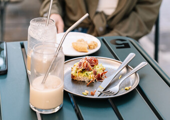 Finishing an outdoor brunch with avocado toast and drinks