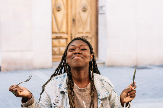 African american woman enjoying food eating outdoors