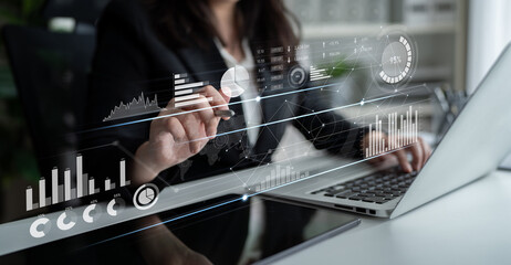 Professional woman analyzing data using a digital tablet in a modern office. The scene features graphs and charts, highlighting insights and financial strategies. Scalp