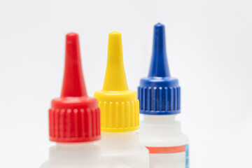 Red, blue and yellow bottles for different contents, small bottles