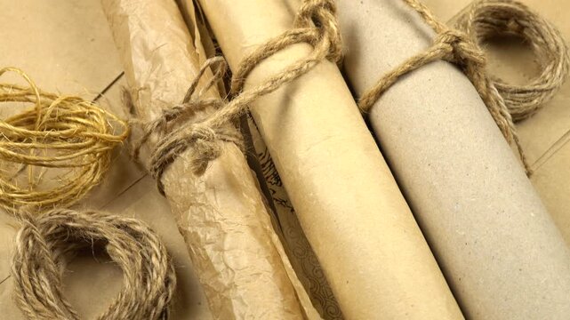 Scrolls of wrapping paper, rotation. Various samples of paper and twines for wrapping. 