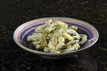 Goya or Nigagori chips, made with katakuriko, salt, olive oil, and tare sauce. The sauce is made with soy sauce, apple cider vinegar, sugar, sake, rayu (a type of rye), and white sesame oil.