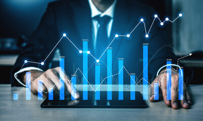 A businessman analyzes financial data trends using a tablet. Graphs and metrics appear around him, reflecting the modern approach to business and growth in a digital workspace. Scalp
