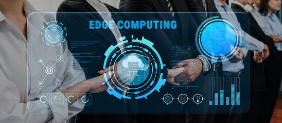 Team of professionals working together on edge computing strategies, showcasing digital interface graphics in a modern office environment focused on innovation. Trope