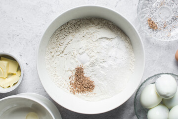nigerian egg roll dough being mixed in a white bowl, process of making egg rolls