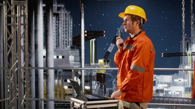 Offshore drilling rig engineer speaking through walkie talkie with colleagues, monitoring oil extraction systems for efficiency. Trying to minimize carbon footprint levels on platform. Camera B.