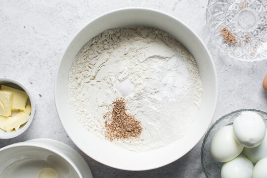 nigerian egg roll dough being mixed in a white bowl, process of making egg rolls