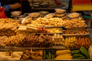 the quintessential scene of a Salty Crispy Chicken (Xian Su Ji) stall in a Taiwanese night market