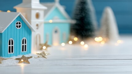Small blue wooden houses with golden star lights and soft holiday ambience