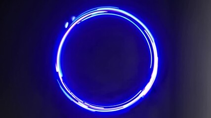 Vibrant circular neon light flashing and changing colors against a dark background, creating a futuristic and dynamic visual effect perfect for modern abstract concepts or backgrounds - Powered by Adobe
